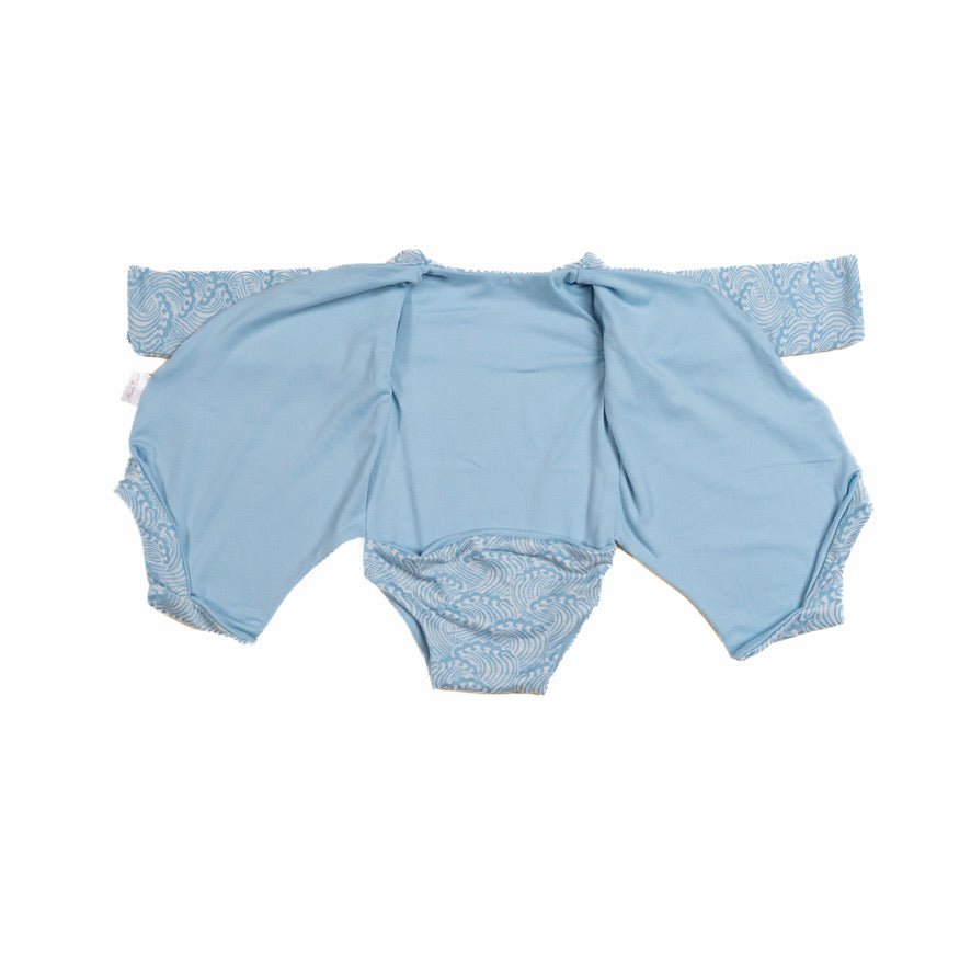 Long sleeved reversible winged bodysuit for babies in classic brushed fabric.