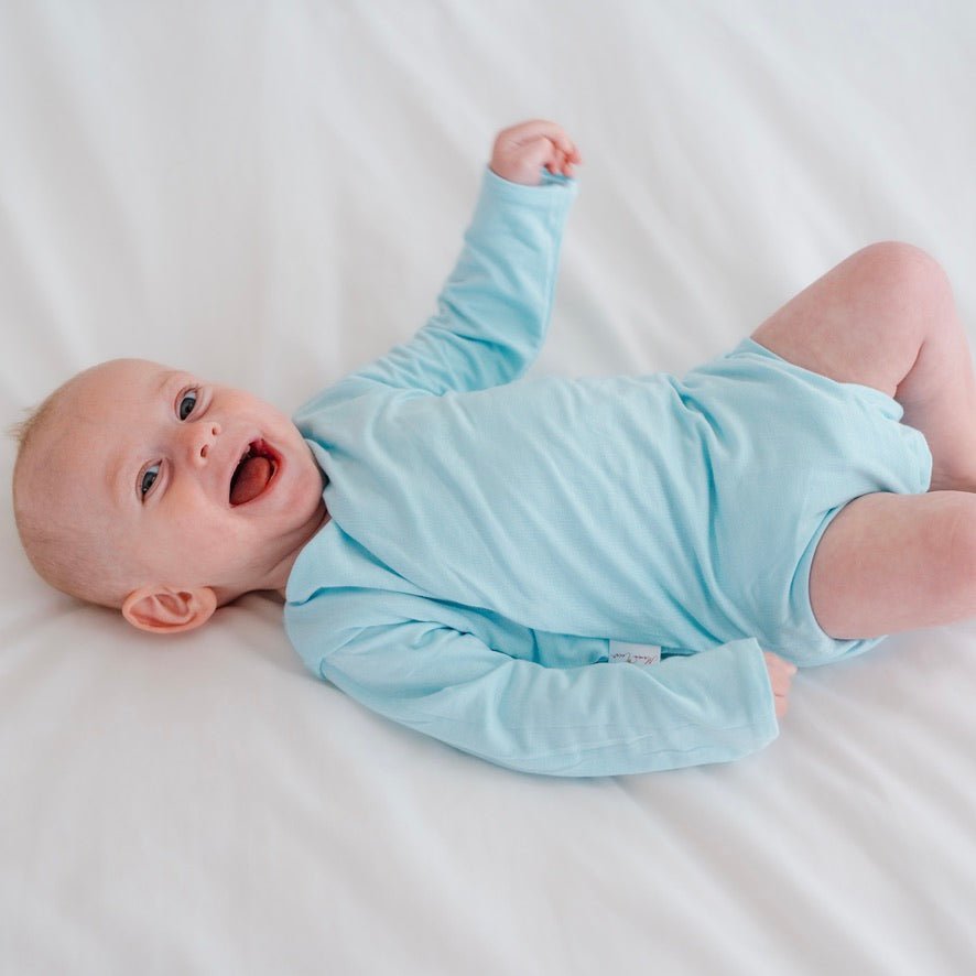 Long sleeved reversible winged bodysuit for babies in silky modal fabric.