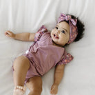 Peachy Lilac headwrap for babies, featuring a stylish bow detail.