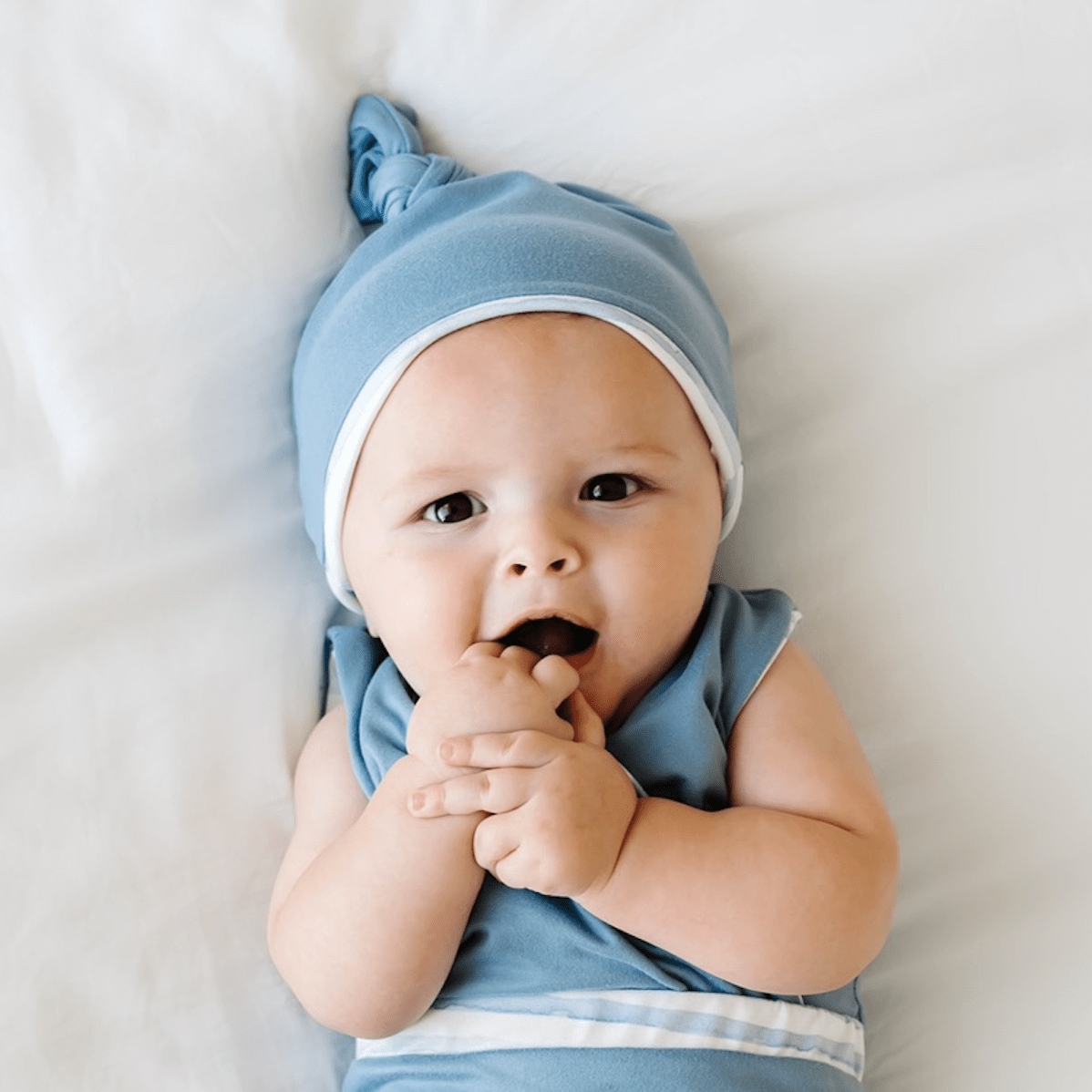Reversible onesie outfit in chambray waves design includes beanie and winged bodysuit.