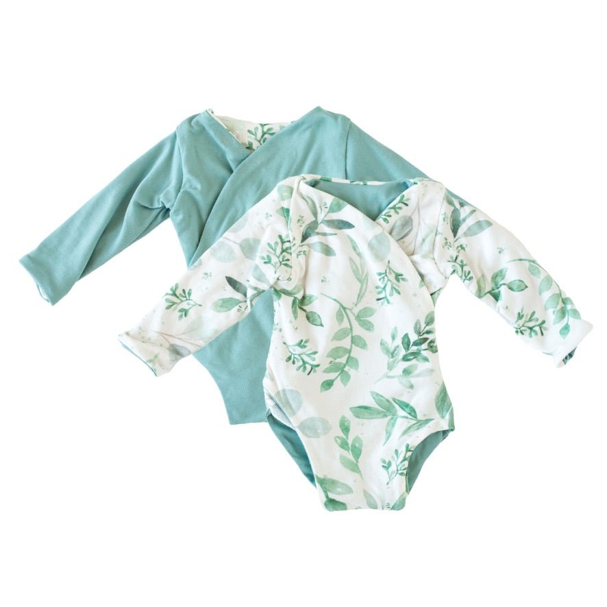 Reversible long-sleeve winged bodysuit in saged eucalyptus design.