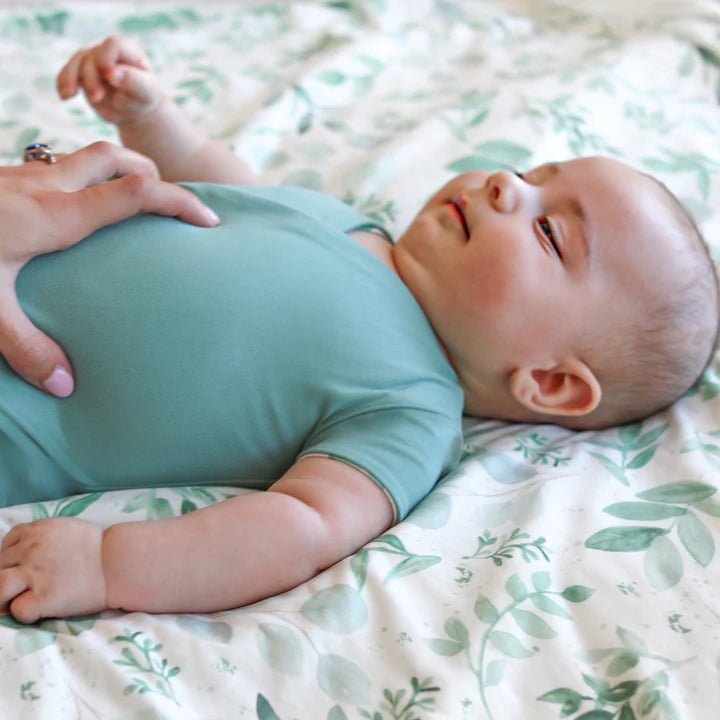 Reversible winged bodysuit in saged eucalyptus design.
