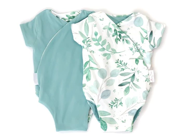 Reversible winged bodysuit in saged eucalyptus design.