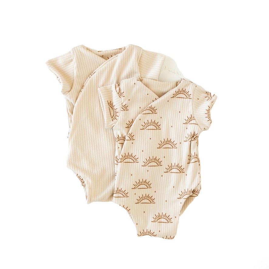 Reversible short-sleeve winged bodysuit in a sandy sunsets design.
