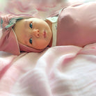 Adorable reversible ruched beanie with bow for babies in Blushing Eucalyptus with a soft stretchy fit.