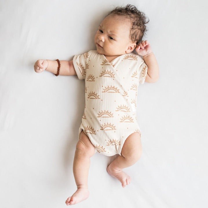 Reversible short-sleeve winged bodysuit in sandy sunsets design.