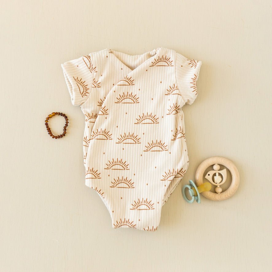 Soft classic brushed short-sleeve winged bodysuit in the Sandy Sunsets design for comfortable everyday wear.