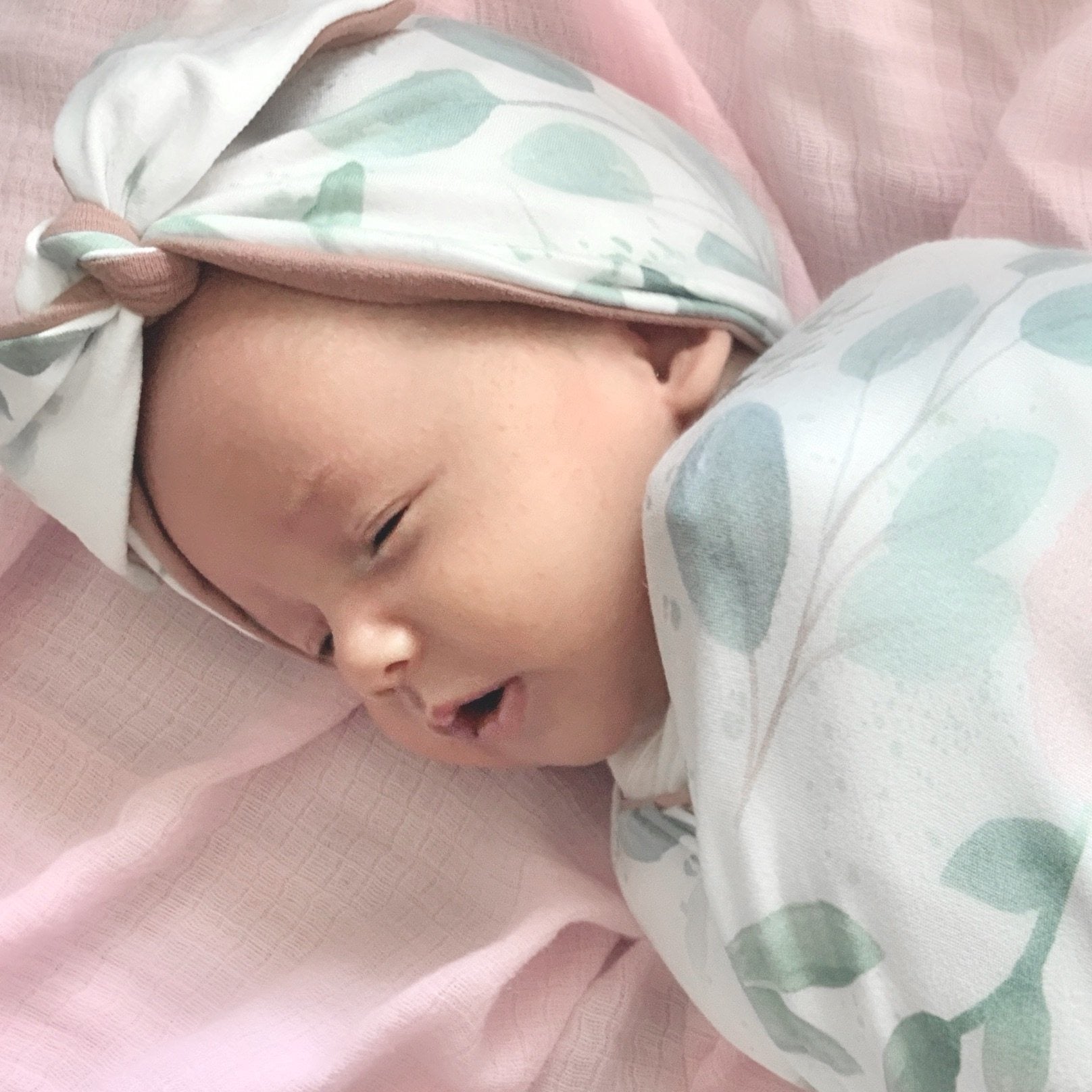 Cozy ruched beanie with bow for babies featuring the gentle Blushing Eucalyptus print.