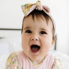 Cozy ruched beanie with bow for babies featuring the gentle Pink Lemonade print.